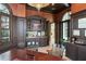 Elegant home office with custom cabinetry, a wet bar, and ample natural light at 11900 Lake Butler Blvd, Windermere, FL 34786