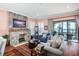 Cozy living room with stone fireplace, hardwood floors, comfortable seating, and a view of the water at 11900 Lake Butler Blvd, Windermere, FL 34786