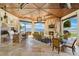 This outdoor living space features a full kitchen, fireplace, and panoramic lake views at 11900 Lake Butler Blvd, Windermere, FL 34786