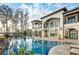Enjoy the water view from this custom pool and spa surrounded by mature landscaping at 11900 Lake Butler Blvd, Windermere, FL 34786