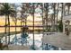 Enjoy the water view from this custom pool and spa surrounded by mature landscaping at 11900 Lake Butler Blvd, Windermere, FL 34786