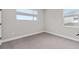 Well-lit bedroom with carpet flooring and multiple windows at 13415 Laxness St, Orlando, FL 32827