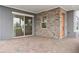 Covered patio with stone wall and sliding glass door at 13415 Laxness St, Orlando, FL 32827