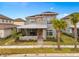 Two-story home with gray siding, stone accents, and a metal roof at 13415 Laxness St, Orlando, FL 32827