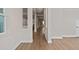 Bright hallway with wood flooring and view into kitchen at 13415 Laxness St, Orlando, FL 32827