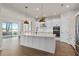 Open kitchen with island, stainless steel appliances, and access to backyard at 13415 Laxness St, Orlando, FL 32827