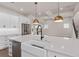 Modern kitchen island with farmhouse sink and black faucet at 13415 Laxness St, Orlando, FL 32827