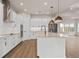 Modern kitchen with white cabinets, quartz countertops, and a farmhouse sink at 13415 Laxness St, Orlando, FL 32827