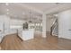 Open concept kitchen with island and stainless steel appliances, view of stairs at 13415 Laxness St, Orlando, FL 32827