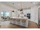 Modern kitchen featuring white cabinets, quartz countertops, and an island at 13415 Laxness St, Orlando, FL 32827