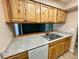 Well-equipped kitchen featuring wood cabinets and granite countertops at 1404 Oak Pl # J, Apopka, FL 32712