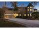 A two-story house with a turret, illuminated at night, showcasing a long driveway at 1415 Brumley Rd, Chuluota, FL 32766