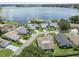 Aerial view of lakefront homes with solar panels at 1423 Grand Cayman Cir, Winter Haven, FL 33884