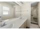 Bathroom with double vanity and walk-in shower at 1423 Grand Cayman Cir, Winter Haven, FL 33884
