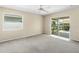 Bright bedroom with carpet flooring and sliding glass doors to a patio at 1423 Grand Cayman Cir, Winter Haven, FL 33884