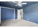Bedroom with blue walls, carpet, and a closet at 1423 Grand Cayman Cir, Winter Haven, FL 33884