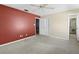 Bedroom with red accent wall and ceiling fan at 1423 Grand Cayman Cir, Winter Haven, FL 33884