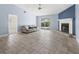 Spacious living room with tile floors, fireplace and access to backyard at 1423 Grand Cayman Cir, Winter Haven, FL 33884
