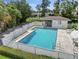 Community pool with a fenced area and covered patio at 1423 Grand Cayman Cir, Winter Haven, FL 33884