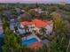 Aerial view showcases the home's layout and pool surrounded by lush, mature greenery at 1446 Berkshire Ave, Winter Park, FL 32789