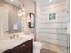 Elegant bathroom features a modern shower with glass door, stylish vanity, and sophisticated lighting fixtures at 1446 Berkshire Ave, Winter Park, FL 32789