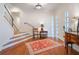 Welcoming foyer with hardwood floors, a staircase with a black railing, and a side table at 1446 Berkshire Ave, Winter Park, FL 32789