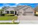 House with two-car garage and landscaped lawn at 15239 Firelight Dr, Winter Garden, FL 34787