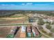 Aerial view of houses in a community near a golf course and lake at 16324 Vetta Dr, Montverde, FL 34756