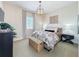 Bright bedroom featuring a floral comforter and key art at 16324 Vetta Dr, Montverde, FL 34756