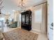Bright entryway with a large rug, cabinet, and view to the living room at 16324 Vetta Dr, Montverde, FL 34756