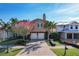 Tan two-story house with two-car garage, landscaping, and a view of neighboring homes under construction at 16324 Vetta Dr, Montverde, FL 34756