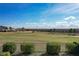 Scenic view of a lush green golf course beyond a fence at 16324 Vetta Dr, Montverde, FL 34756