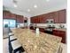 Large kitchen island with granite countertop and seating at 16324 Vetta Dr, Montverde, FL 34756
