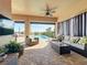 Covered lanai with seating area and pool access at 16324 Vetta Dr, Montverde, FL 34756