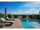 Two lounge chairs beside a refreshing blue swimming pool at 16324 Vetta Dr, Montverde, FL 34756