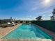 Inviting rectangular pool with pristine blue water, surrounded by lush landscaping at 16324 Vetta Dr, Montverde, FL 34756