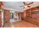 Cozy living room flows into the kitchen, featuring a brick accent wall and built-in shelving at 191 Royal Dunes Cir, Ormond Beach, FL 32176