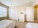 Bright bedroom with two twin beds and closet at 2093 Leather Fern Dr, Ocoee, FL 34761