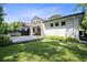 Spacious backyard with a well-maintained lawn, deck, pergola and lush landscaping at 2315 Depauw Ave, Orlando, FL 32804