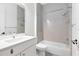 Clean bathroom featuring a vanity sink, toilet, and tiled tub and shower at 2315 Depauw Ave, Orlando, FL 32804