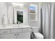 Clean bathroom featuring a tiled shower, bright white sink, toilet, and a window at 2315 Depauw Ave, Orlando, FL 32804