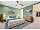 Green bedroom with king bed, matching end tables, and artwork; ensuite bathroom and closet are visible at 2315 Depauw Ave, Orlando, FL 32804