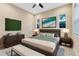 Spacious main bedroom featuring a king bed, ceiling fan, decorative art, and bedside tables with lamps at 2315 Depauw Ave, Orlando, FL 32804