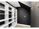 Walk-in closet with black walls, white shelves, and wood-style flooring at 2315 Depauw Ave, Orlando, FL 32804
