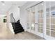 Modern entryway with black staircase and glass French doors at 2315 Depauw Ave, Orlando, FL 32804