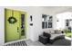 Inviting front porch with a lime-green door and wicker seating at 2315 Depauw Ave, Orlando, FL 32804