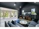 Cozy living room with dark walls, balcony access, and comfortable seating arrangement at 2315 Depauw Ave, Orlando, FL 32804