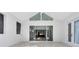 Bright open-concept living room featuring a vaulted ceiling and access to the backyard at 2315 Depauw Ave, Orlando, FL 32804
