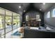 Spacious living room with dark grey walls, recessed lighting, a modern entertainment center, and a walk-out balcony at 2315 Depauw Ave, Orlando, FL 32804