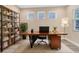 Modern home office featuring a stylish wooden desk, large windows, and built-in shelving for ample storage at 2315 Depauw Ave, Orlando, FL 32804